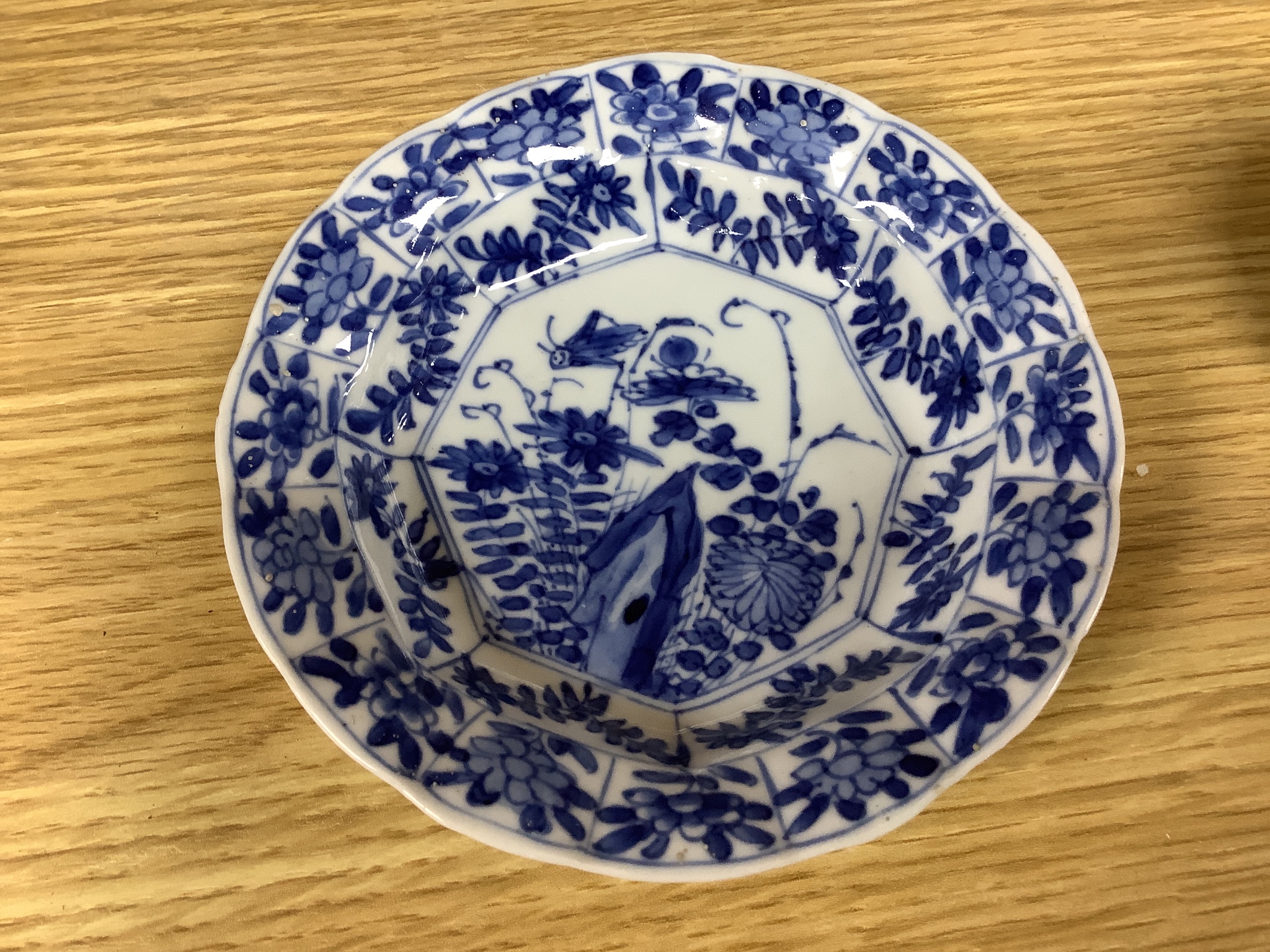 A Chinese blue and white plate 13cm diameter, a similar tea bowl and saucer, Kangxi period and a 19th century Chinese blue and white bottle vase